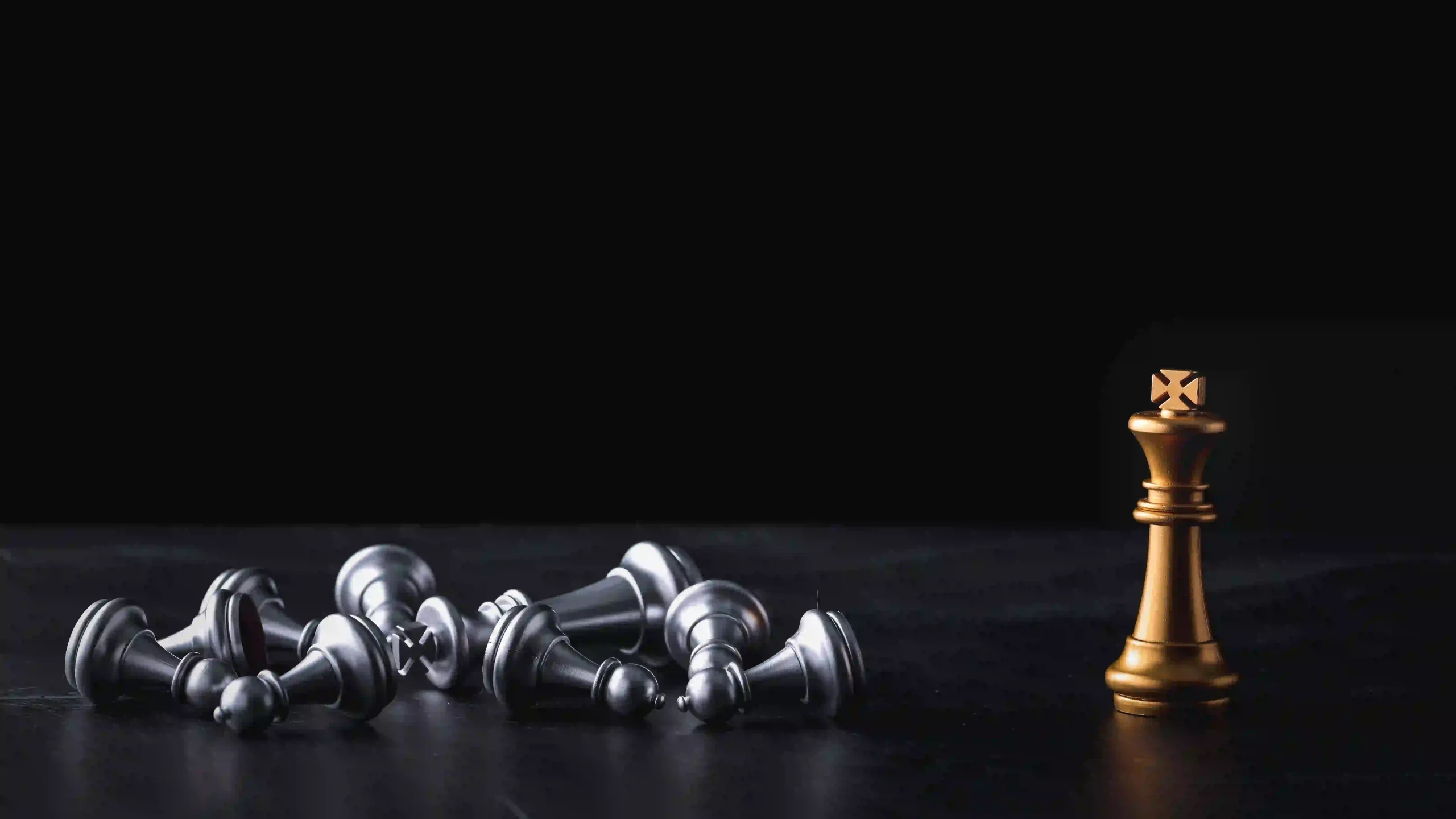 multiple fallen chess pieces with only the queen piece standing